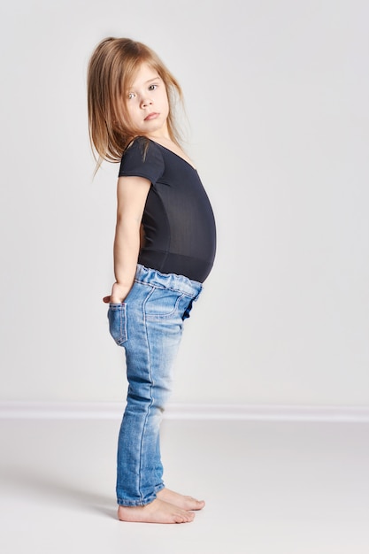 Beautiful little girl in stylish clothes