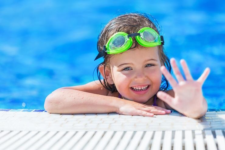 Photo beautiful little girl swimming at the pool