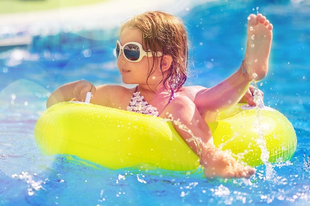 Beautiful little girl at swimming pool