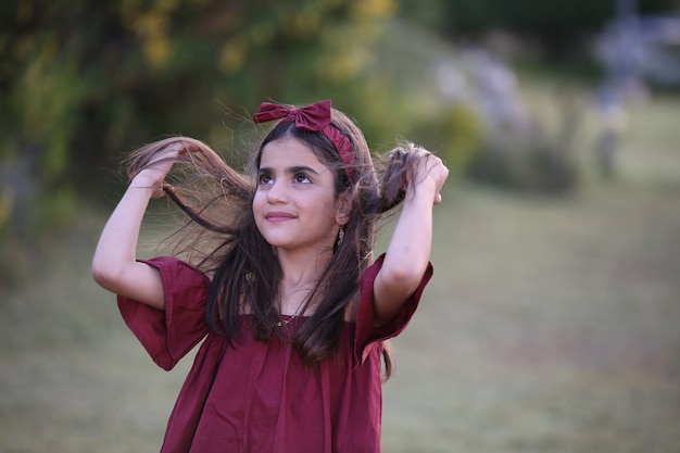 Beautiful Little girl teenager with field house park Outdoors