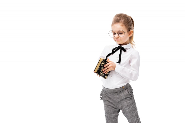 Beautiful little girl in white shirt and gray pants