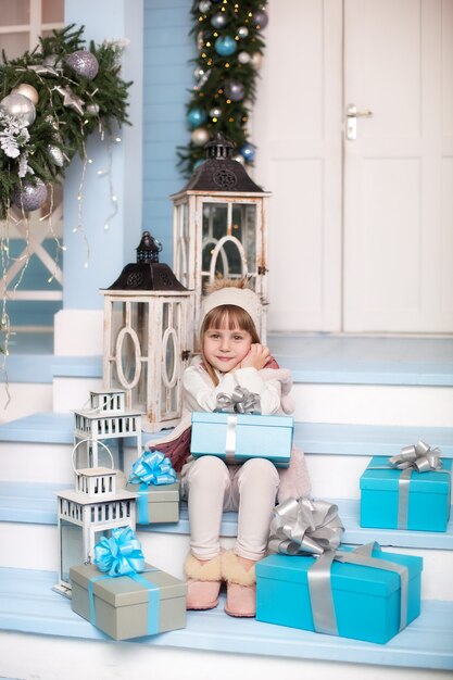 Beautiful little girl with a Christmas gift