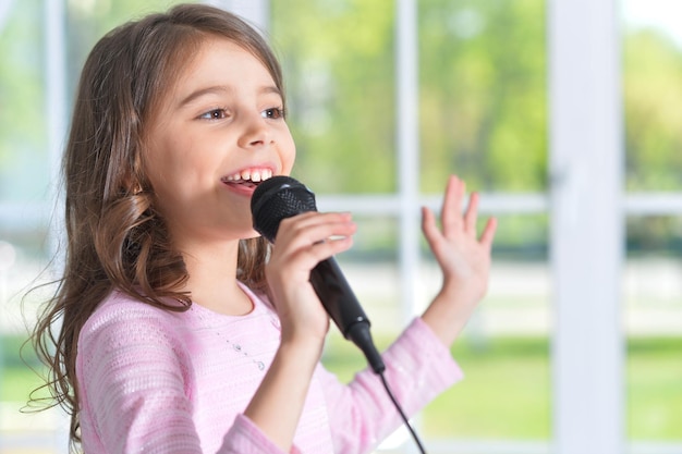 Foto bella bambina con microfono