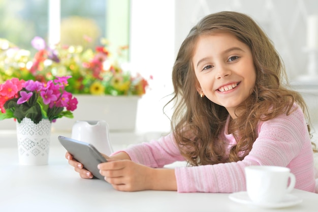 Beautiful little girl with tablet pc