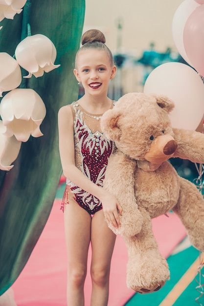 Beautiful little gymnast training on the carpet and ready for competitions