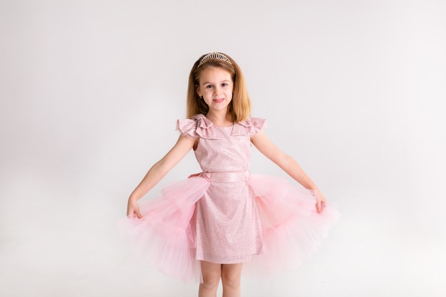 Beautiful little princess dancing in luxury pink dress