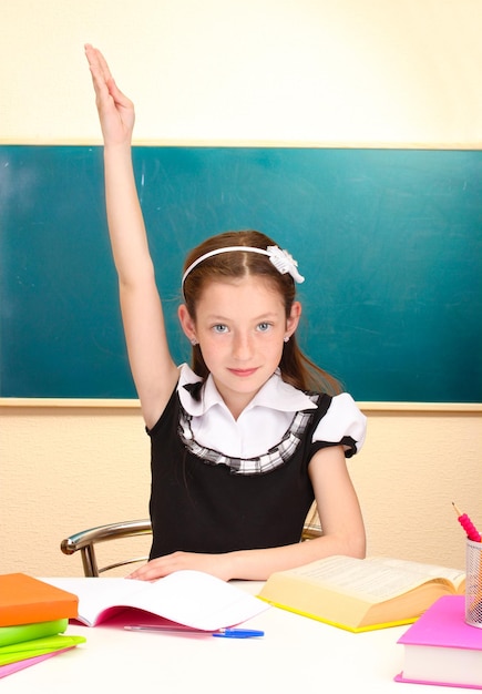 Beautiful little schoolgirl in classroom