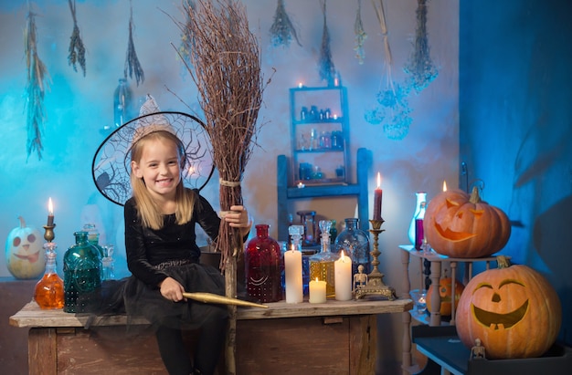 Beautiful little witch with Halloween decorations