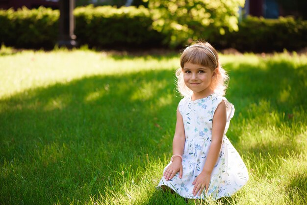 Beautiful little young girl outdoorin a park.