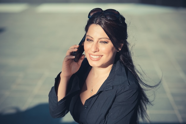 beautiful long black hair elegant business woman using smartphone