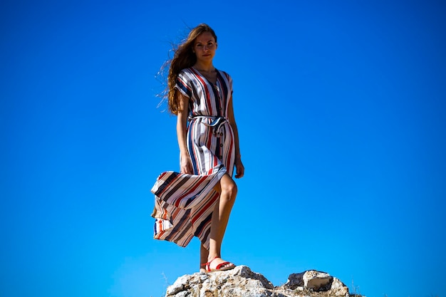 beautiful long-haired girl stands on top of a hill in the middle of nowhere in western australia