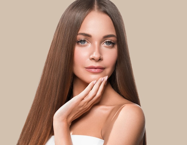 Beautiful long smooth hair woman happy clean skin face color background. Brown.