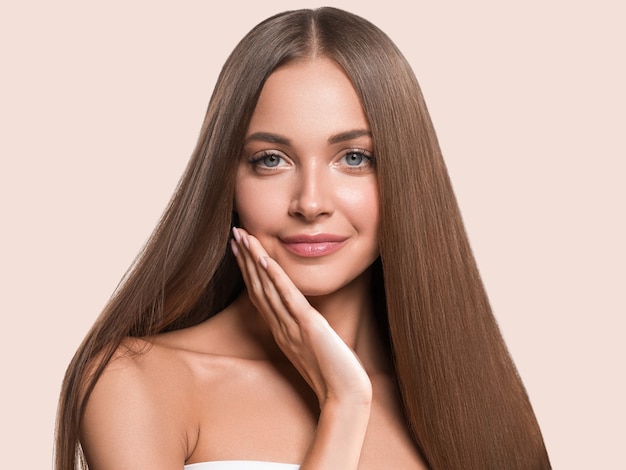 Beautiful long smooth hair woman happy clean skin face color background. Pink