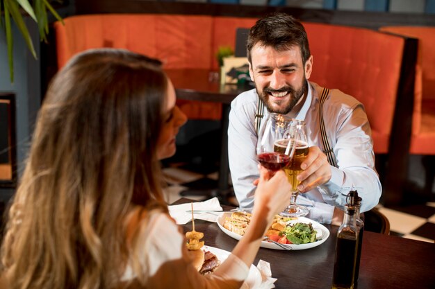 Beautiful loving couple is spending time together in modern restaurant