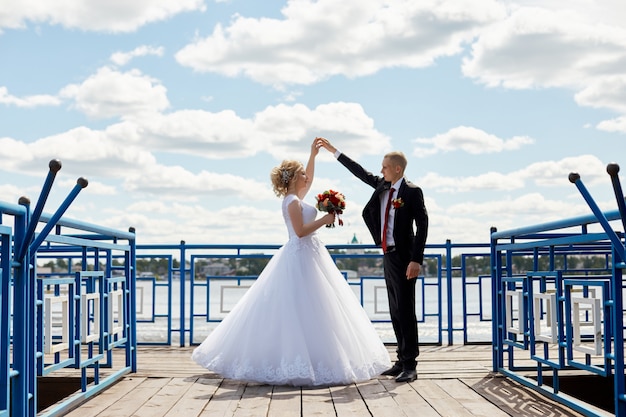 Beautiful loving wedding couple registers a marriage and walks along the beautiful promenade