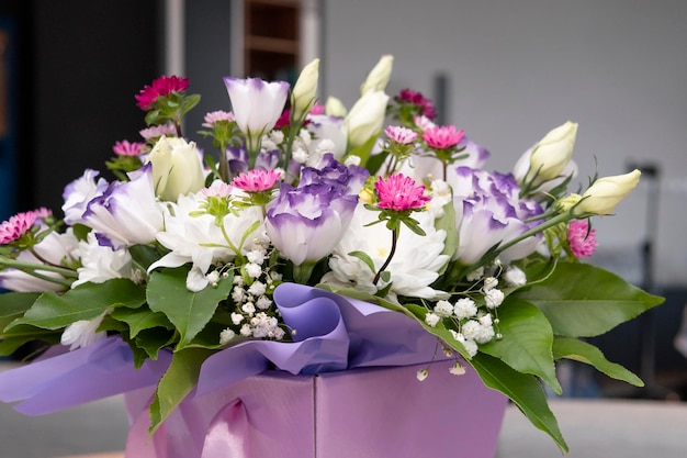 Beautiful luxury bouquets of eustoma and mix flowers in the box closeup