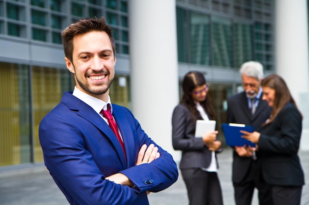 Beautiful man on the background of business people