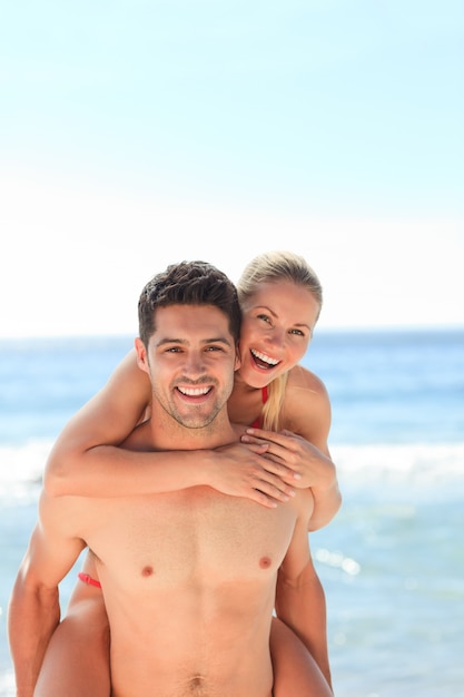 Beautiful man having girlfriend a piggyback