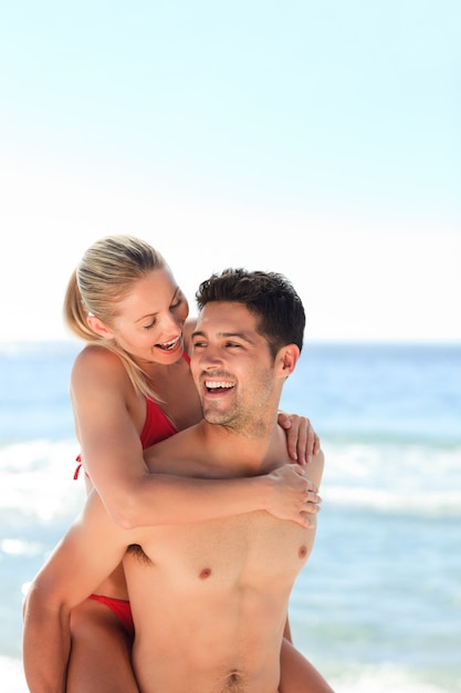 Beautiful man having girlfriend a piggyback