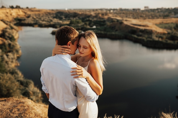 Beautiful man and woman hugging each other tenderly. Two together, young family on sunny day.