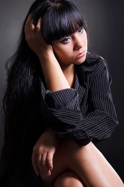 Beautiful and mature adult caucasian woman with red lips dark hair and brown eyes wearing a black leather jacket striped black and white top and a lace hat