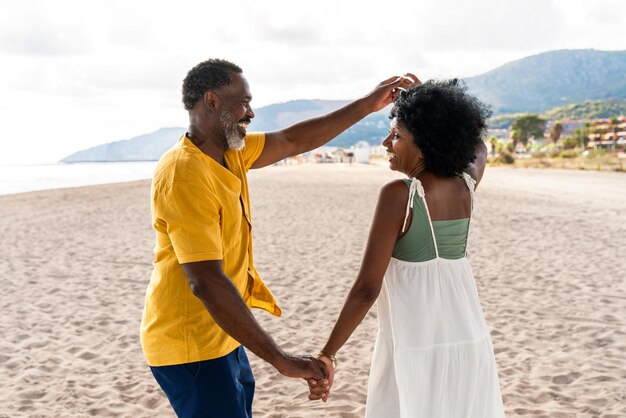 Beautiful mature black couple of lovers dating at the seaside