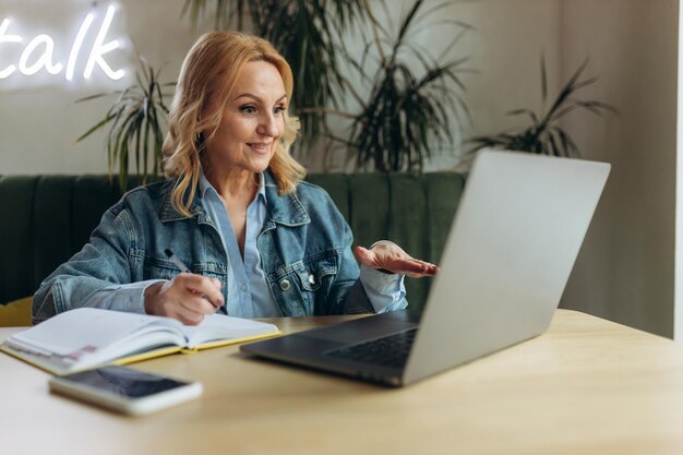 Beautiful mature businesswoman using laptop