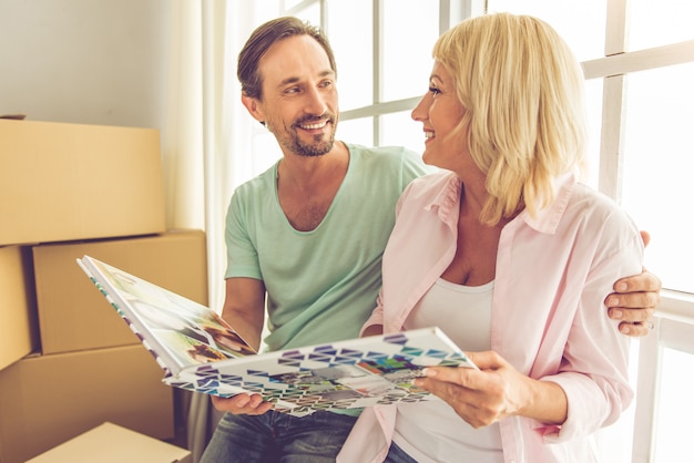 Beautiful mature couple is viewing photo album.