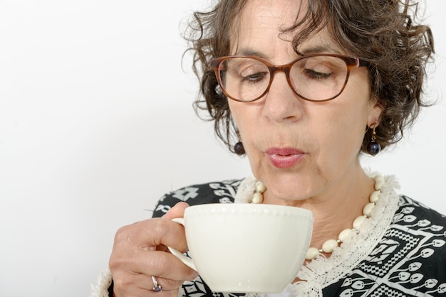 Beautiful mature woman drinking tea