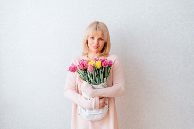 Beautiful mature woman holding tulips