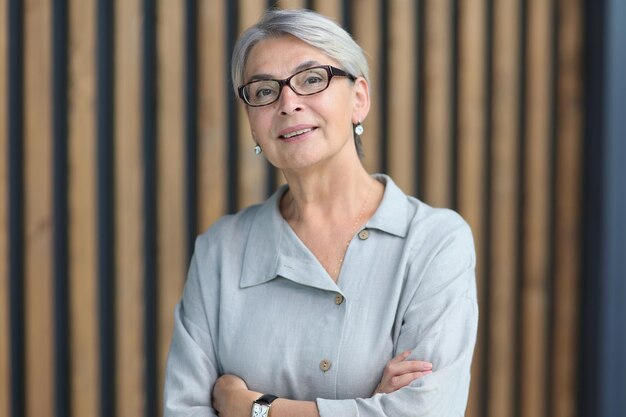 Beautiful mature woman in office arms crossed