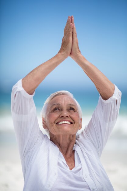 Beautiful mature woman posing with hands joined