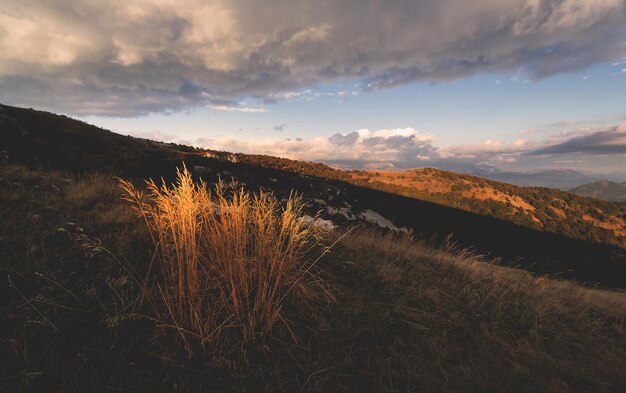 Beautiful meadows on the hill at sunset in autumn season