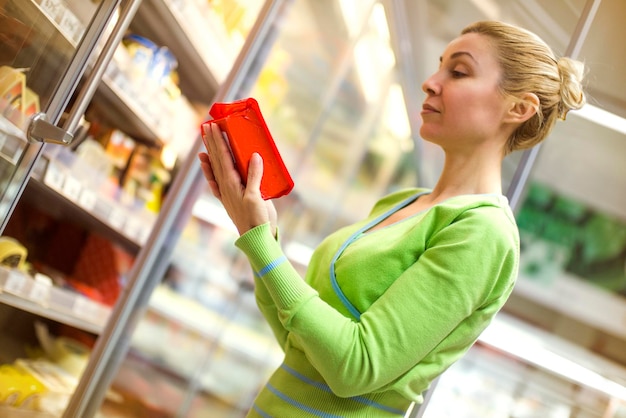 Beautiful mid adult woman shopping in a supermarket