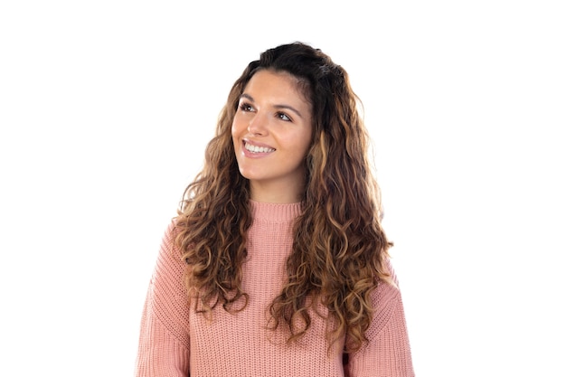 Beautiful middle aged woman with pink woolen sweater isolated on a white wall