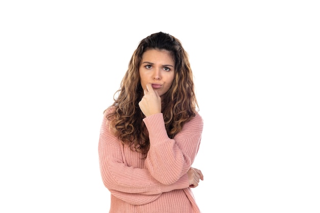 Beautiful middle aged woman with pink woolen sweater isolated on a white wall