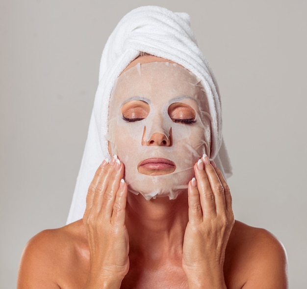 Beautiful middle aged woman with a towel on her head.