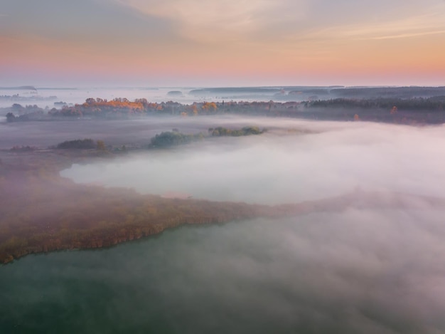 Beautiful misty dawn Flying above the clouds aerial view