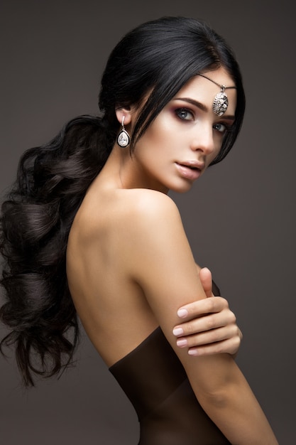 Beautiful model brunette with long curled hair