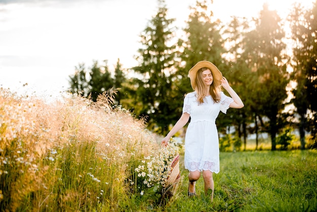 Beautiful Model girl in white dress running on the Field, Sun Light . Free Happy Woman. Toned in warm colors. Selective focus.