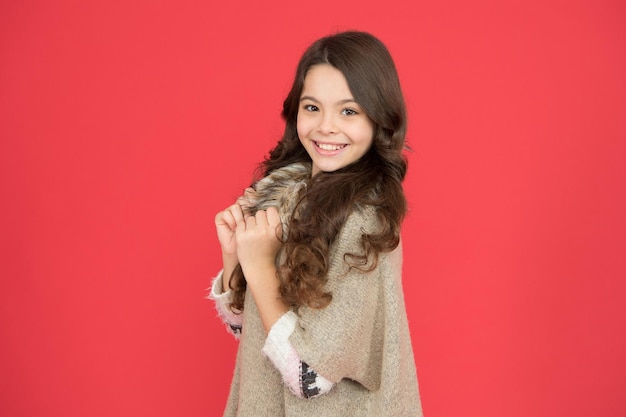 Beautiful model kid fashion concept best shampoos and\
conditioners for lush hair nourish dull and damaged hair girl long\
curly hair little beauty smiling red background happy\
childhood