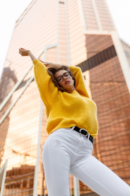 Beautiful model posing upside down while holding her hands in the air