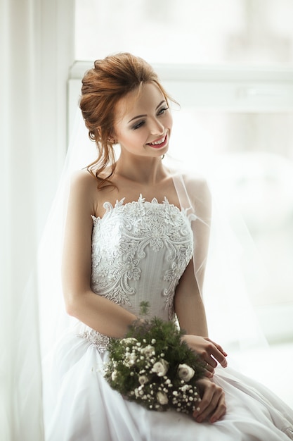 Beautiful model wearing white lace dress is posing