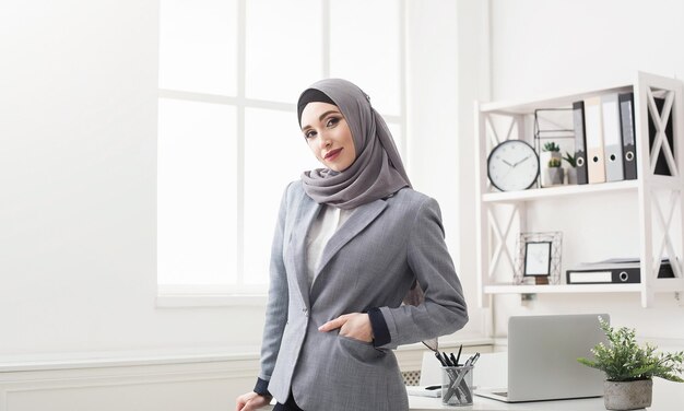 Beautiful modern Muslim businesswoman portrait in office