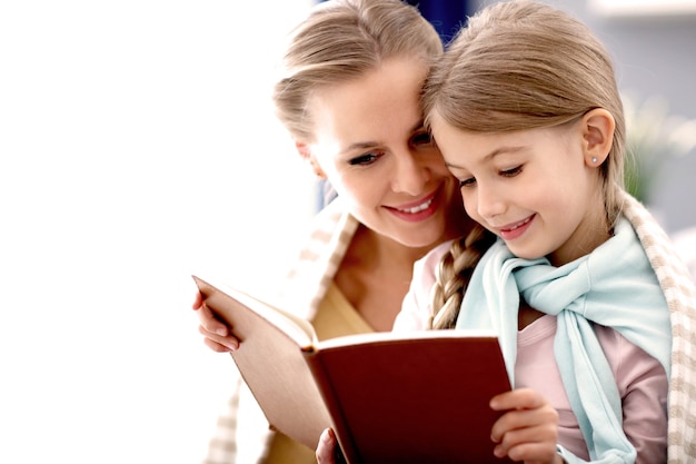 beautiful mom and her daughter having fun at home