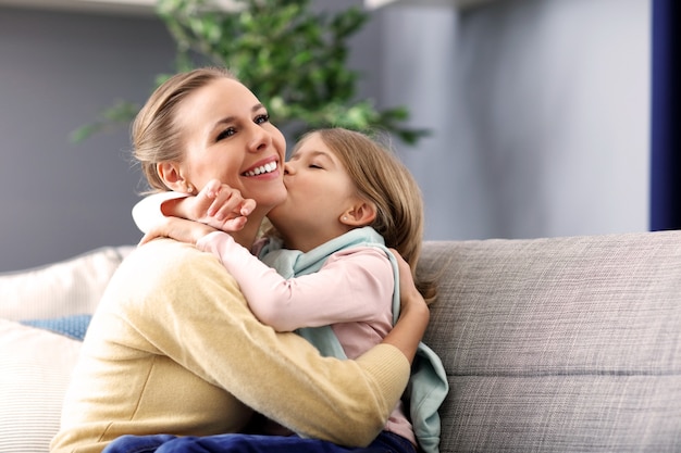 beautiful mom and her daughter having fun at home