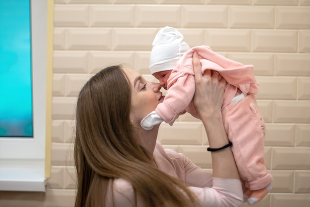 Beautiful mom with little newborn daughter