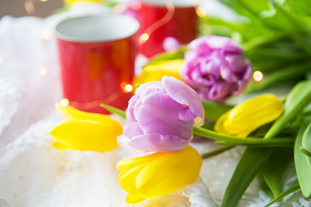 Beautiful morning, two cups of coffee and a bouquet of bright and beautiful tulips.