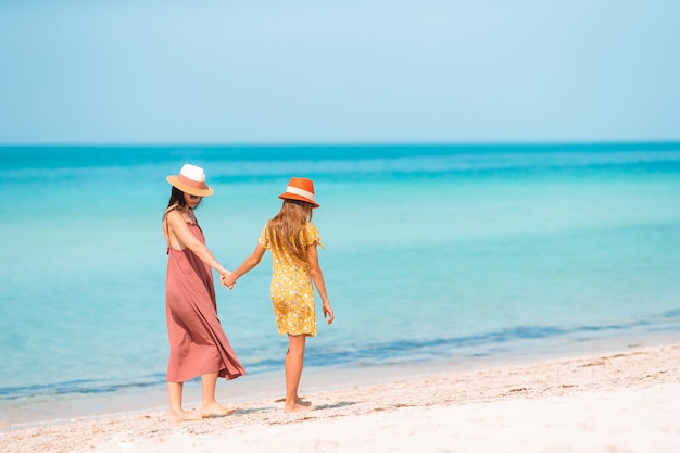 Beautiful mother and daughter on the beach