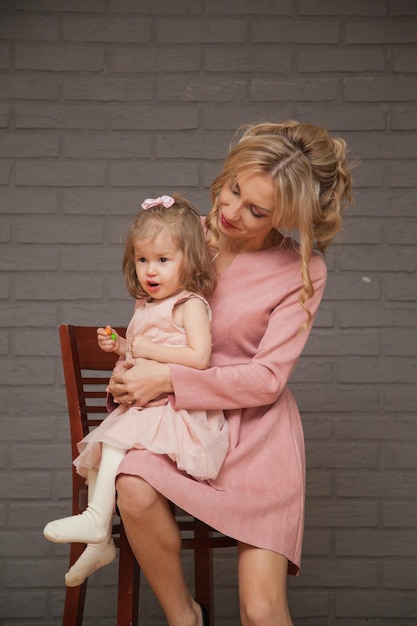 Beautiful mother and daughter in pink dresses